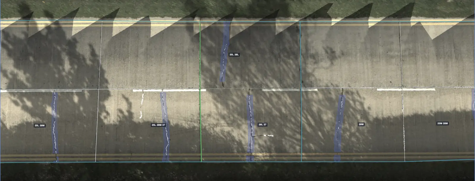 Jointed concrete road from above, partly in tree shadow, with every slab outlined and its joints and cracks traced and labeled with ASTM distress codes like 25L and 28M