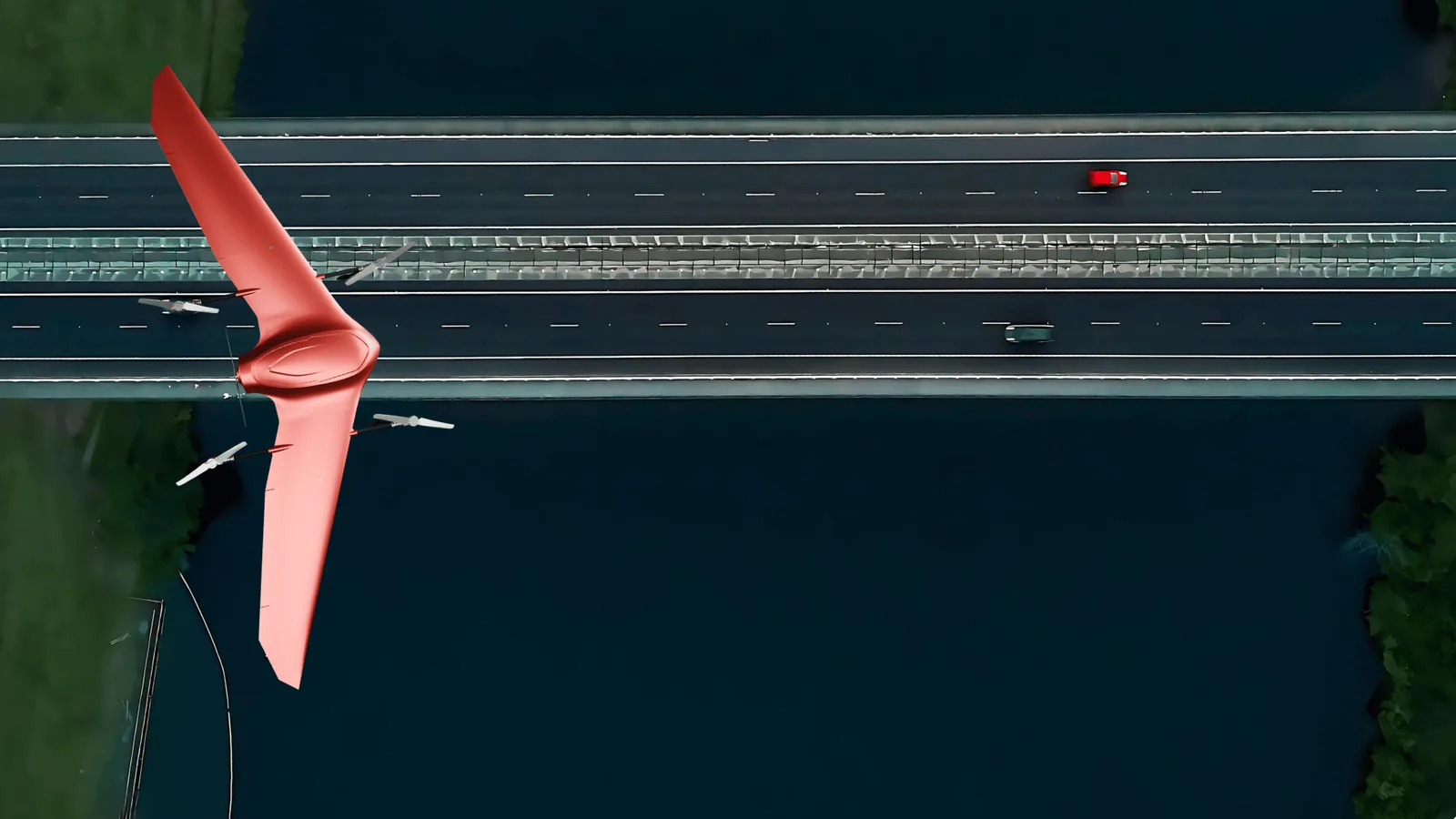 Top-down aerial of a multi-lane divided highway with a Nimbus drone flying the corridor
