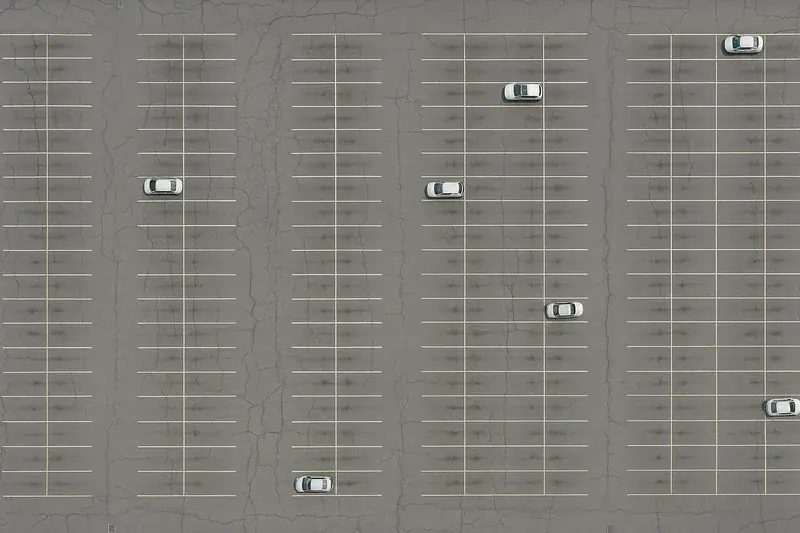 Straight-down aerial of a large parking lot with painted stalls
