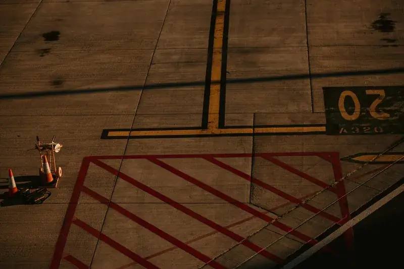Low-altitude aerial of runway pavement with chevron markings